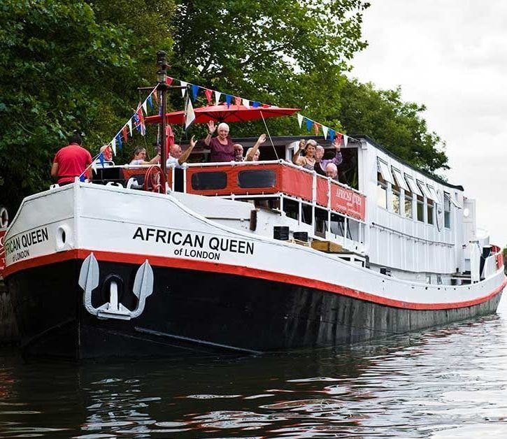 People enjoying a river boat cruise on the Thames