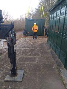 A photograph of workmen installing a disabled toilet at Chilterns Open Air Museum
